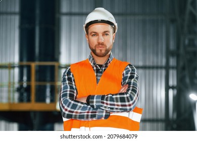 Close Up View. Construction Worker In Uniform Is In The Factory.