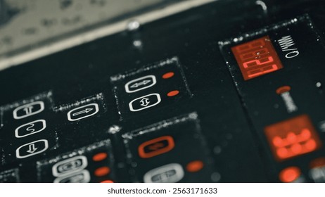 Close up view of a control panel displaying various settings, indicators, and a digital timer, suggesting the intricate operation of industrial equipment