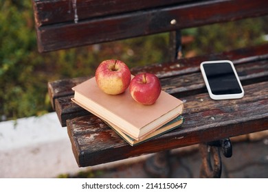 Close Up View Of Couch, And Books, Apples And Smartphone On It.