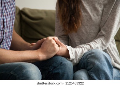 Close up view of couple holding hands, loving wife supporting or comforting husband ready to help expressing sympathy, encouraging and understanding in marriage relationships, reconciliation concept - Shutterstock ID 1125433322