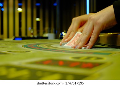 Close Up View Of Dealer Shuffling Cards In Hands