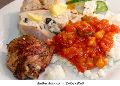 A Close Up View Of A Delious South African Braai Or Barbecue Lunch, Chicken, Mealie Meal With Gravy, Fresh Bread And Salad