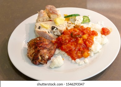 A Close Up View Of A Delious South African Braai Or Barbecue Lunch, Chicken, Mealie Meal With Gravy, Fresh Bread And Salad