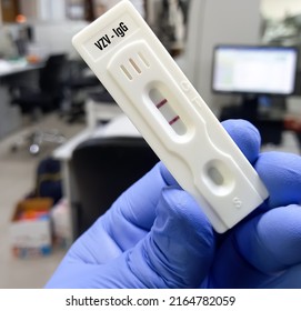 Close view of a device for varicella-zoster virus (VZV) rapid screening test, showing positive result.
