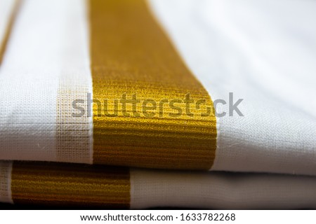 Close view of the dhoti with gold threaded border. Dhoti is a traditional south indian dress wore by men during festivals, marriages.