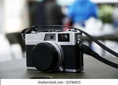 Close view of a digital camera on top of a table.