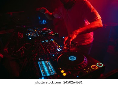 Close up view of a dj's hands playing the mixer while performing