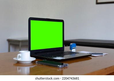 Close Up View Of Doctor's Office Laptop With Mock Up Green Screen Browsing Internet At Work Desk. Healthcare Medical E Health Website Technology Concept