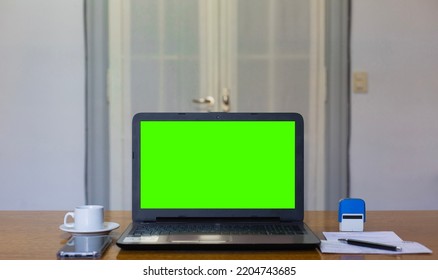 Close Up View Of Doctor's Office Laptop With Mock Up Green Screen Browsing Internet At Work Desk. Healthcare Medical E Health Website Technology Concept