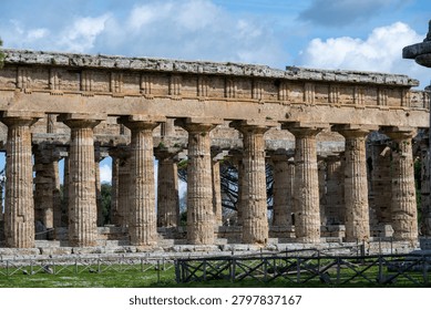 Close view of Doric limestone columns and entablature at Parco Archeologico di Paestum, Capaccio Paestum, Campania, Italy.