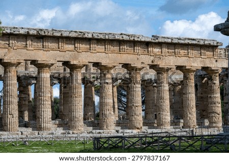 Close view of Doric limestone columns and entablature at Parco Archeologico di Paestum, Capaccio Paestum, Campania, Italy.