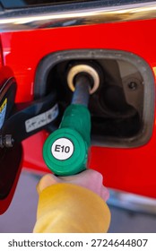 Close view of E10 fuel nozzle refueling car