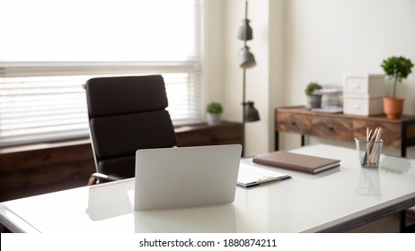 Close Up View Of Empty Employee Desk Workplace With Computer And Documents On It. Crop Image Of Office Worker Table Workspace With Laptop And Papers And Journal. Business, Employment Concept.