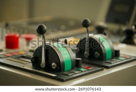 Close up view of engine controls fitted on the bridge of a merchant ship underway at sea