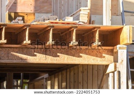 A close view of engineered lumber joists in a residential construction project