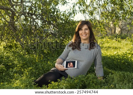 Similar – Unrecognizable pregnant woman showing ultrasound of her baby on the mobile