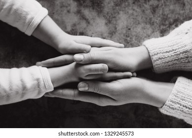 Close Up View Of Family Holding Hands, Loving Caring Mother Supporting Child. Helping Hand And Hope Concept And International Day Of Peace