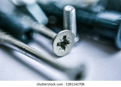Close up view fastening elements bolts  nails  screws  washers  confirmats  dowels blurred the top   bottom photo   Blurred background   selective focus 