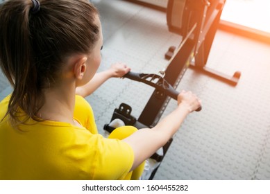 Close Up View Of Female Fitness Instructor Uses A Rowing Machine