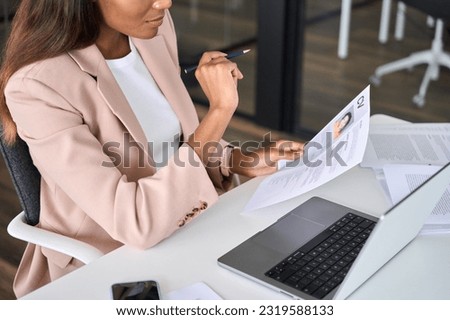 Close up view of female HR manager reading cv during virtual remote online job interview concept. Business woman employer holding resume hiring recruit in professional recruitment agency.