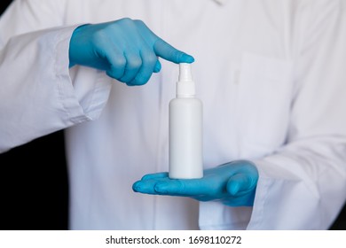 Close up view of female physician hands showing a personal antiseptic or sanitizer. Covid-19 protection measures. Doctor in white medical gown at clean white background. - Shutterstock ID 1698110272