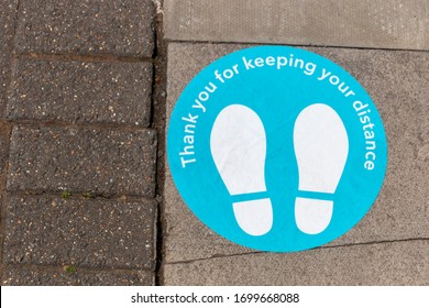 a close up view of floor, steet signage thanking poeple for the two meter distance rule during the coronavirus-COVID 19 epedemic  - Shutterstock ID 1699668088