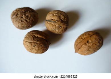 Close View Of Four Ripe Brown Rounded Wrinkly Fruits Of Persian Walnut