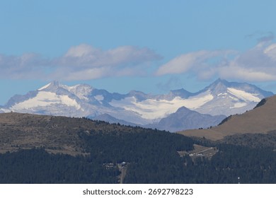 A close view frames distant Dolomites glazed in ice