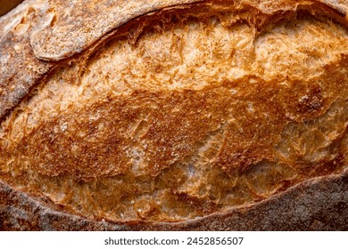 A close view of a freshly baked sourdough bread with a textured, golden crust. - Powered by Shutterstock