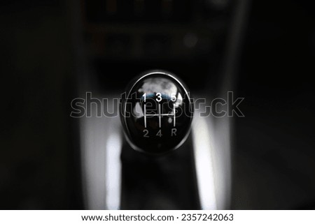 Close up view of a gear lever shift. Manual gearbox. Car interior details. Car transmission. Soft lighting. 