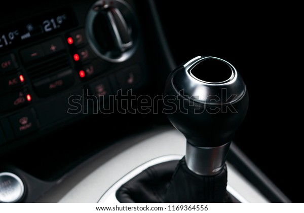 Close up view of a gear lever shift. Manual\
gearbox. Car interior details. Car transmission. Soft lighting.\
Abstract view. Car\
detailing