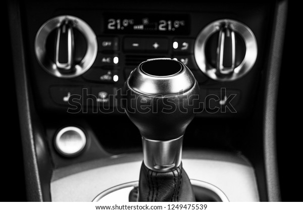 Close up view of a\
gear lever shift. Manual gearbox. Car interior details. Car\
transmission. Soft lighting. Abstract view. Car detailing. Car\
inside. Black and white
