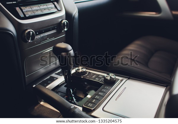 Close up view of a gear lever shift. Manual\
gearbox. Car interior details. Car transmission. Soft lighting.\
Abstract view.