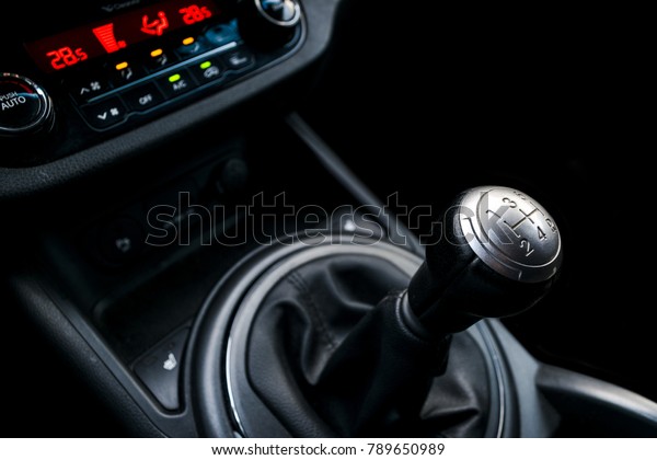 Close up view of a gear lever shift. Manual gearbox. Car\
interior details. Car transmission. Soft lighting. Abstract view.\
