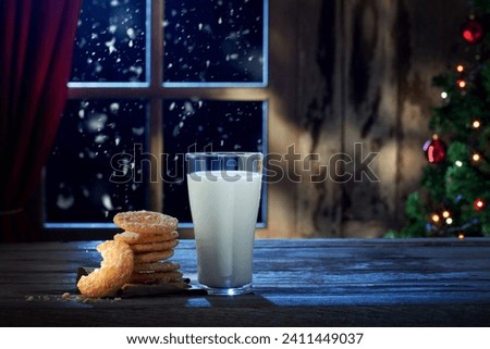 close up view of glass of milk with cookies on color back