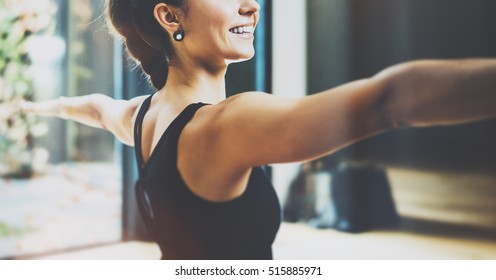 Close up view of gorgeous young woman practicing yoga indoor. Beautiful girl practice Warrior Light asana.Calmness and relax, female happiness concept.Horizontal, blurred background - Powered by Shutterstock