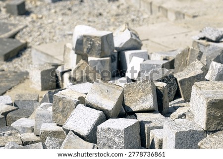 Close view of granite blocks assembled for phased pedestrian paving reinstatement. Symbolizes contractor material sequencing, modular streetscape renewal, and precision-driven civic upgrade planning.