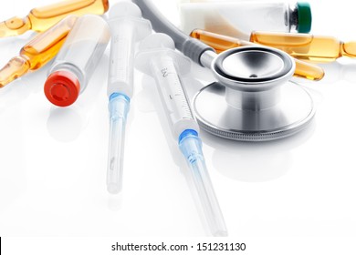 Close up view of grey stethoscope and ampoules  on white back