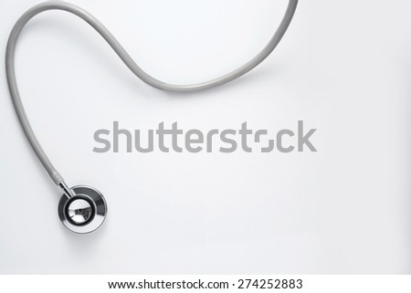 Close up view of grey stethoscope on white back 