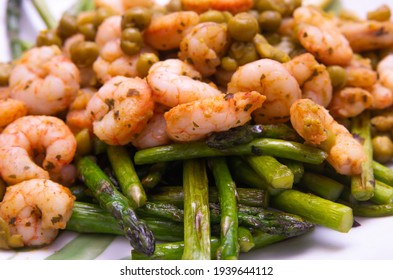 Close Up View Of A Grilled Asparagus, Shrimp And Pea Salad For Lunch On A White Plate