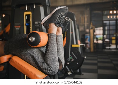 Close Up View Gym Seated Leg Curl Machine Exercise Woman At Indoor.Health Concept.