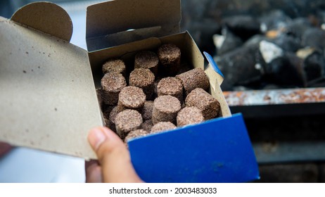 Close Up View Of Hand Holding A Box Of Camping Charcoal Cock Fire Starter For Barbeque Party.