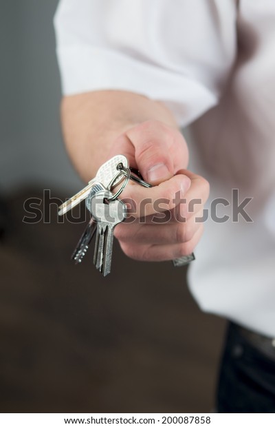 close up\
view of hand with keys. Focus on the\
keys