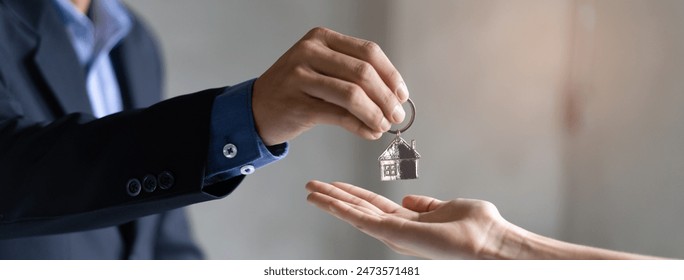 close up view hand of real estate agent realtor landlord giving key house to buyer - Powered by Shutterstock