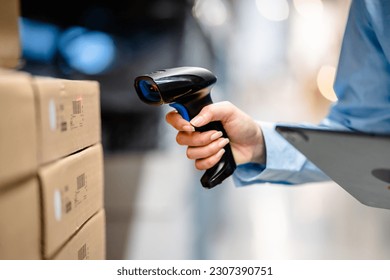 Close up view of Hand women scanning barcodes of stock inventory on shelves to keep storage in a system, Smart warehouse management system, Supply chain and logistic network technology concept.