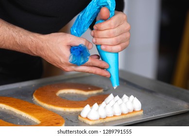 Close Up View, Hands Of The Chef With Confectionery Bag Cream Preparing A Fiftie Years Old Birthday Cake At Pastry Shop Kitchen .