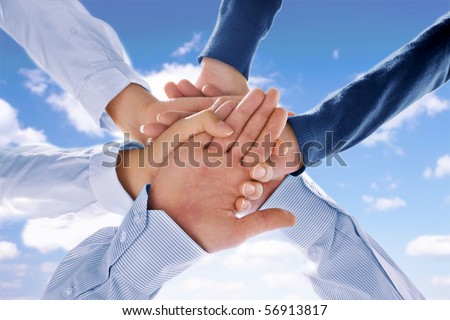 Close up view of hands getting together  on blue background