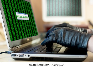 Close up View of Hands of Hacker working on Laptop to hack the Account password using Gloves to avoid leaving fingertips