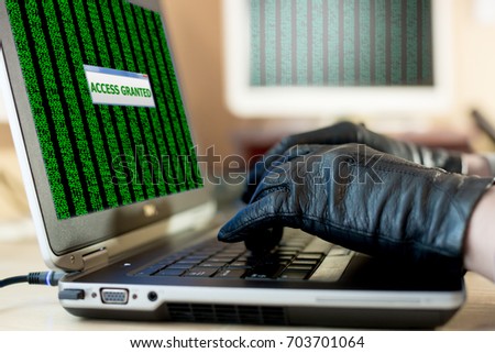 Close up View of Hands of Hacker working on Laptop to hack the Account password using Gloves to avoid leaving fingertips
