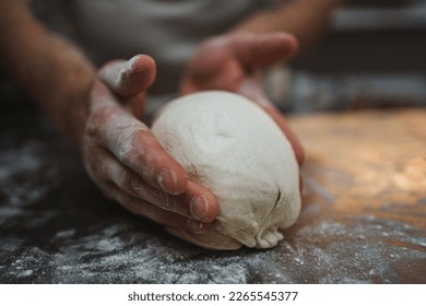 Close up view of hands shaping bread dough in artisan bakery - Powered by Shutterstock